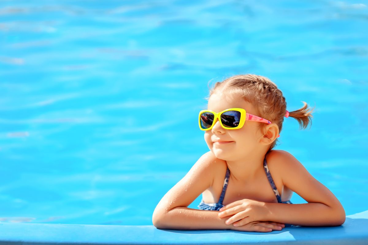 Smiling,Cute,Little,Girl,In,Sunglasses,In,Pool,In,Sunny