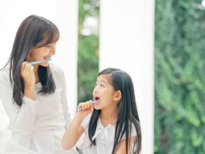 Asian,Girl,Brushing,Her,Teeth,With,Mom.,Dental,Care.,Oral
