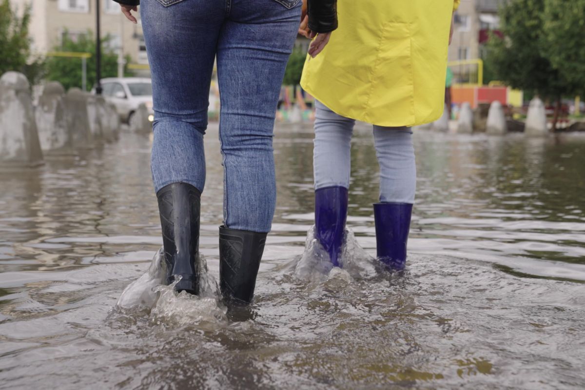 persona camminano con stivali di gomma dopo alluvione