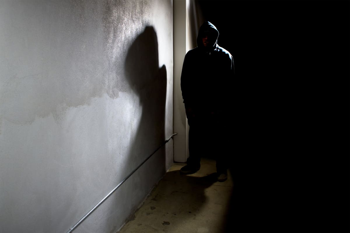 uomo incappucciato stalker ombra buio