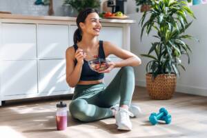 Ragazza si allena in casa e mangia cibo sano