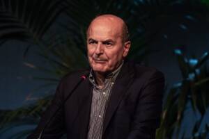 Pier Luigi Bersani discute ad un evento con un abito nero