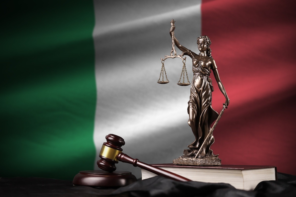 Bandiera italiana, martelletto e statuetta simbolo della Giustizia